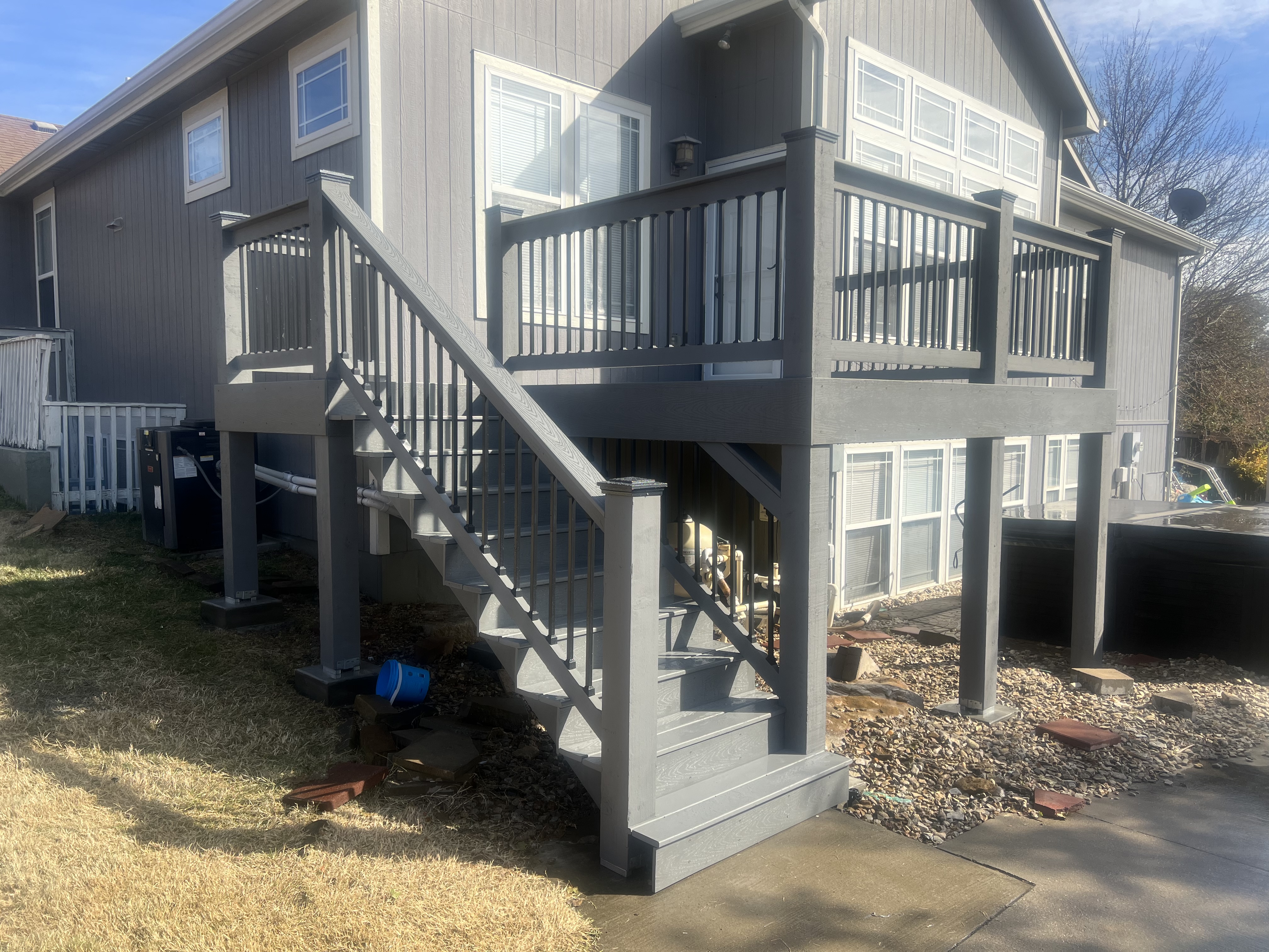 deck with stairs and railing with a gray that matches the house