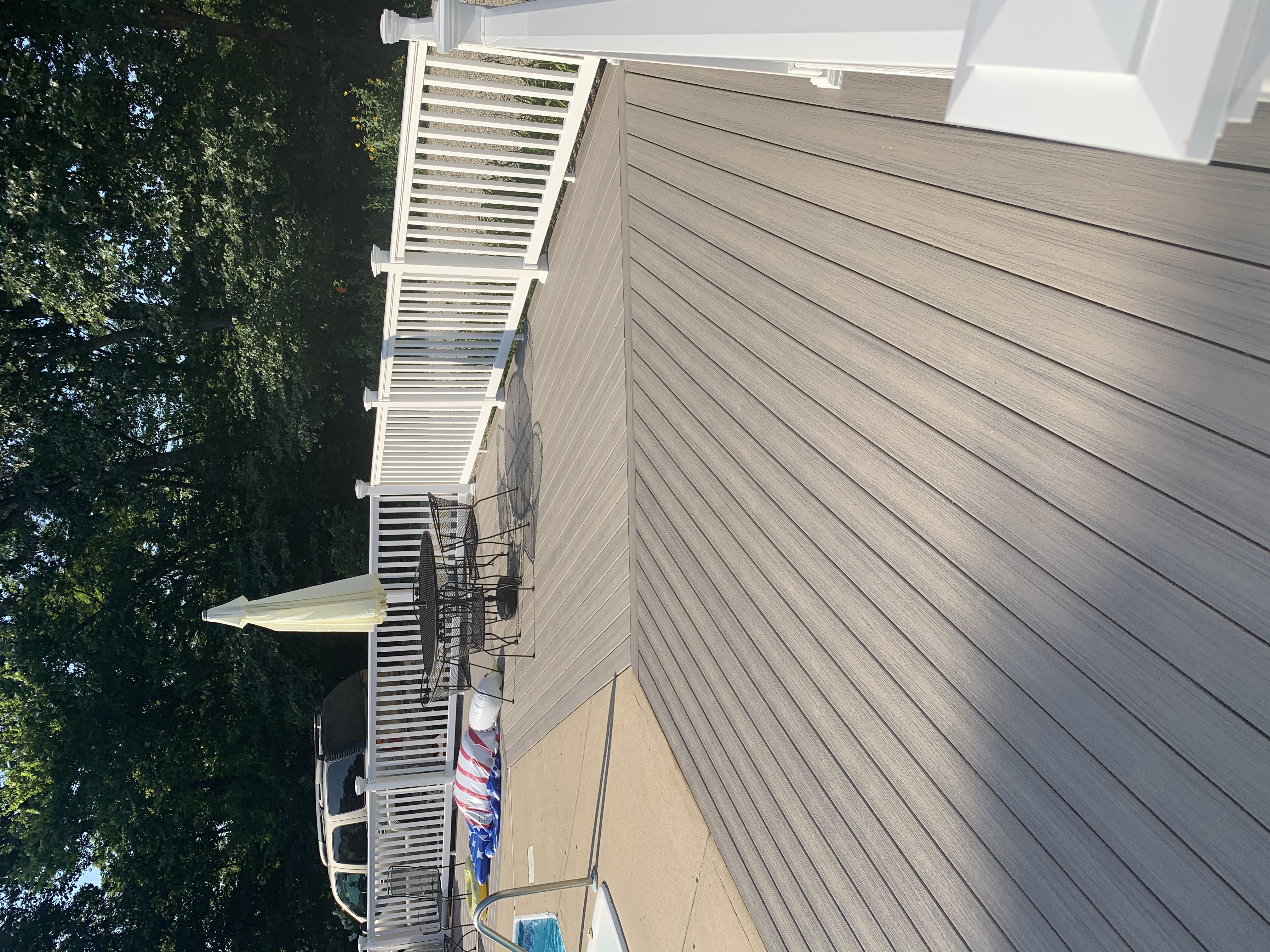 deck with new gray wood flooring and white railing