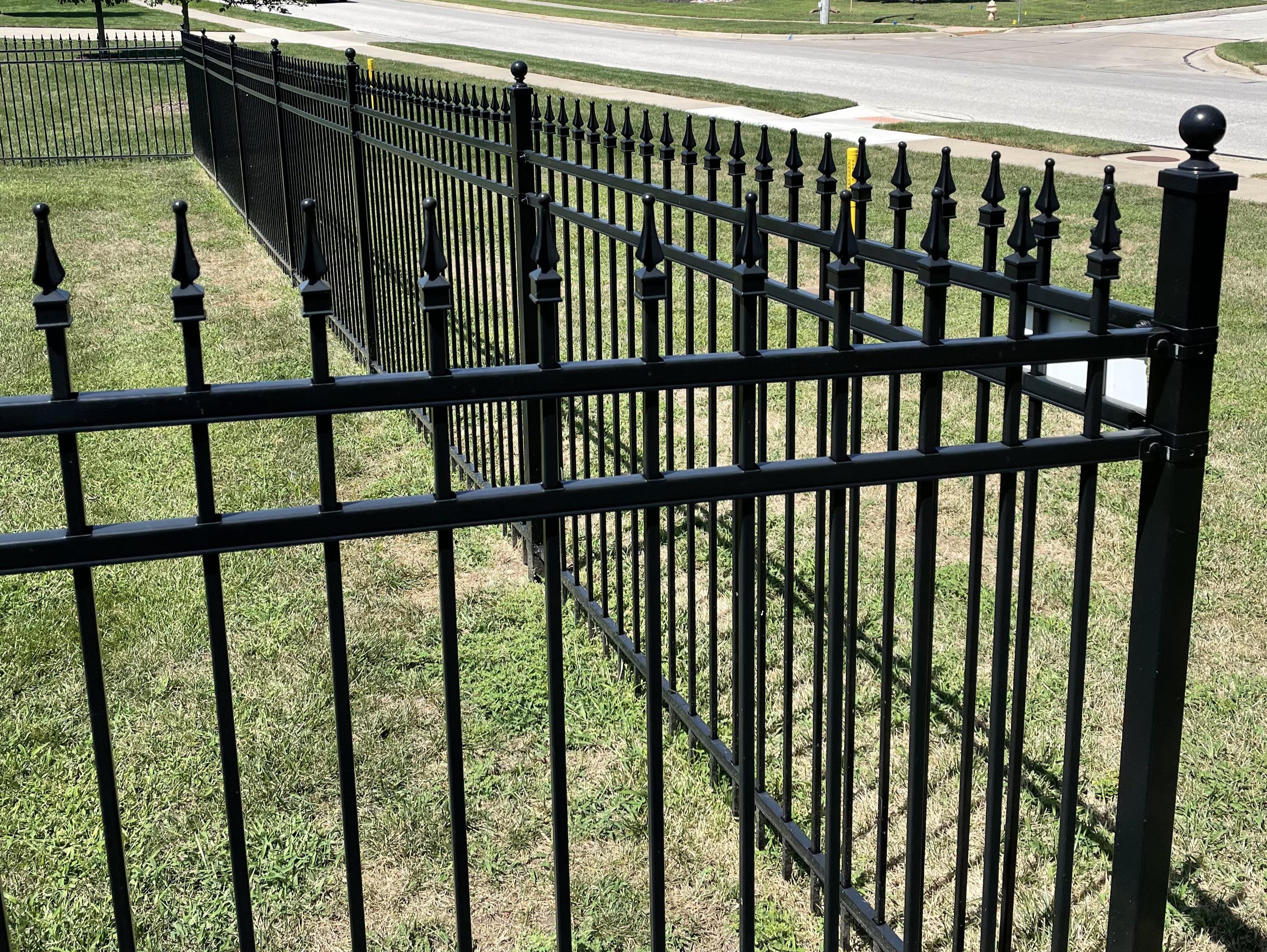 steel fence with pointed top showing how straight it is for 30 feet