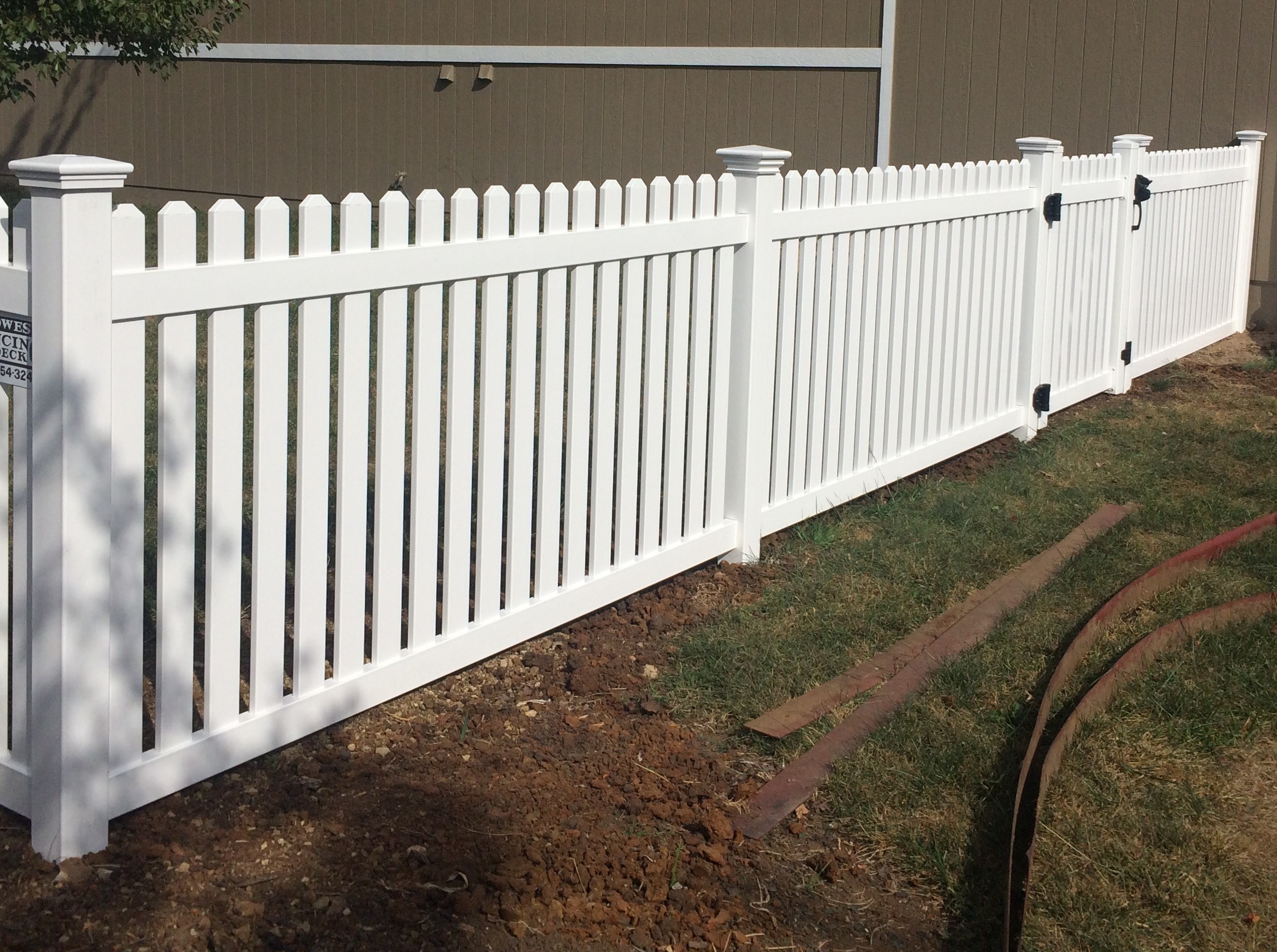 4 foot semi privacy white vinyl fence with a gate