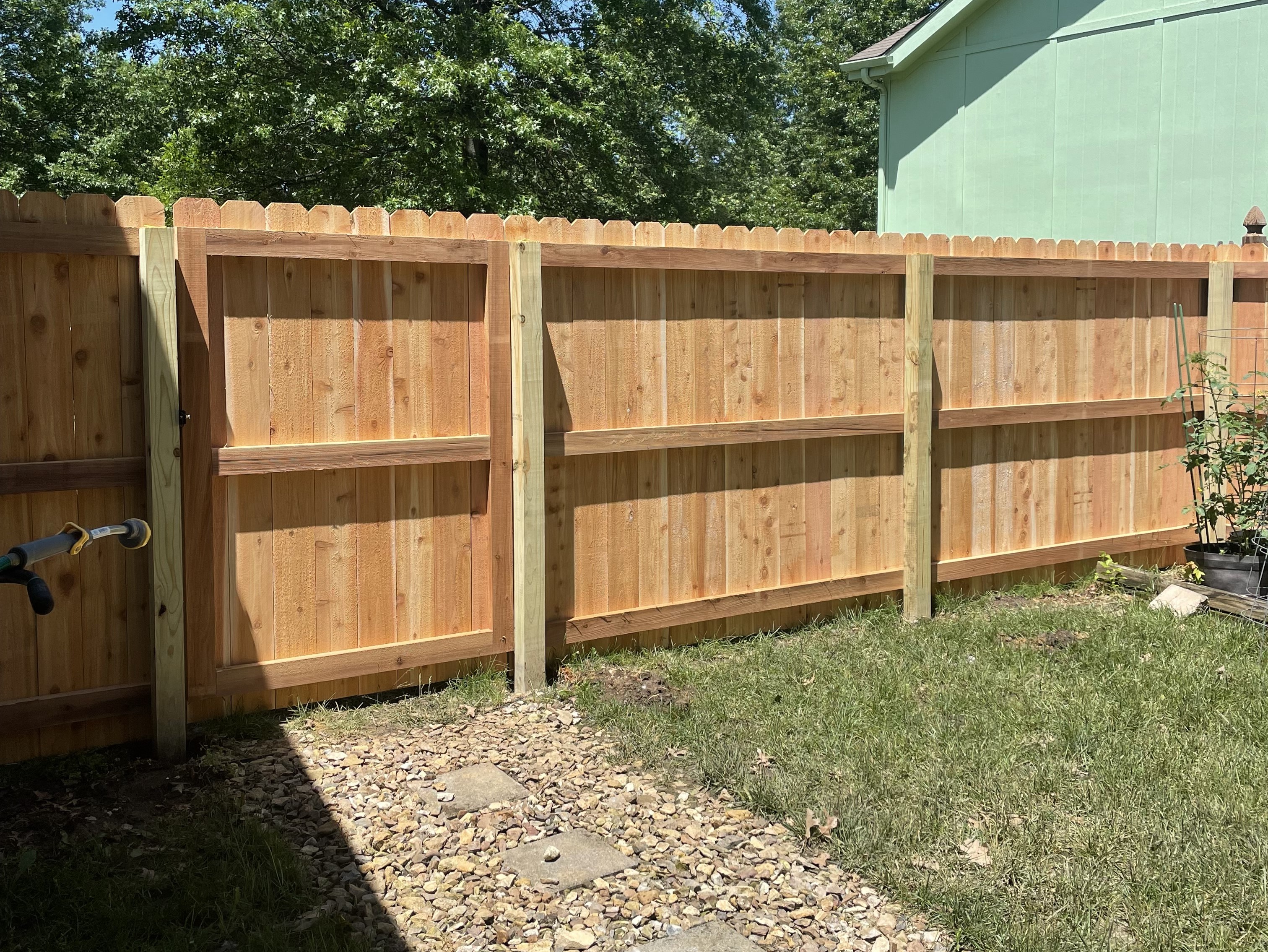 dog Ear Top 6 foot privacy fence with a gate at an inside view
