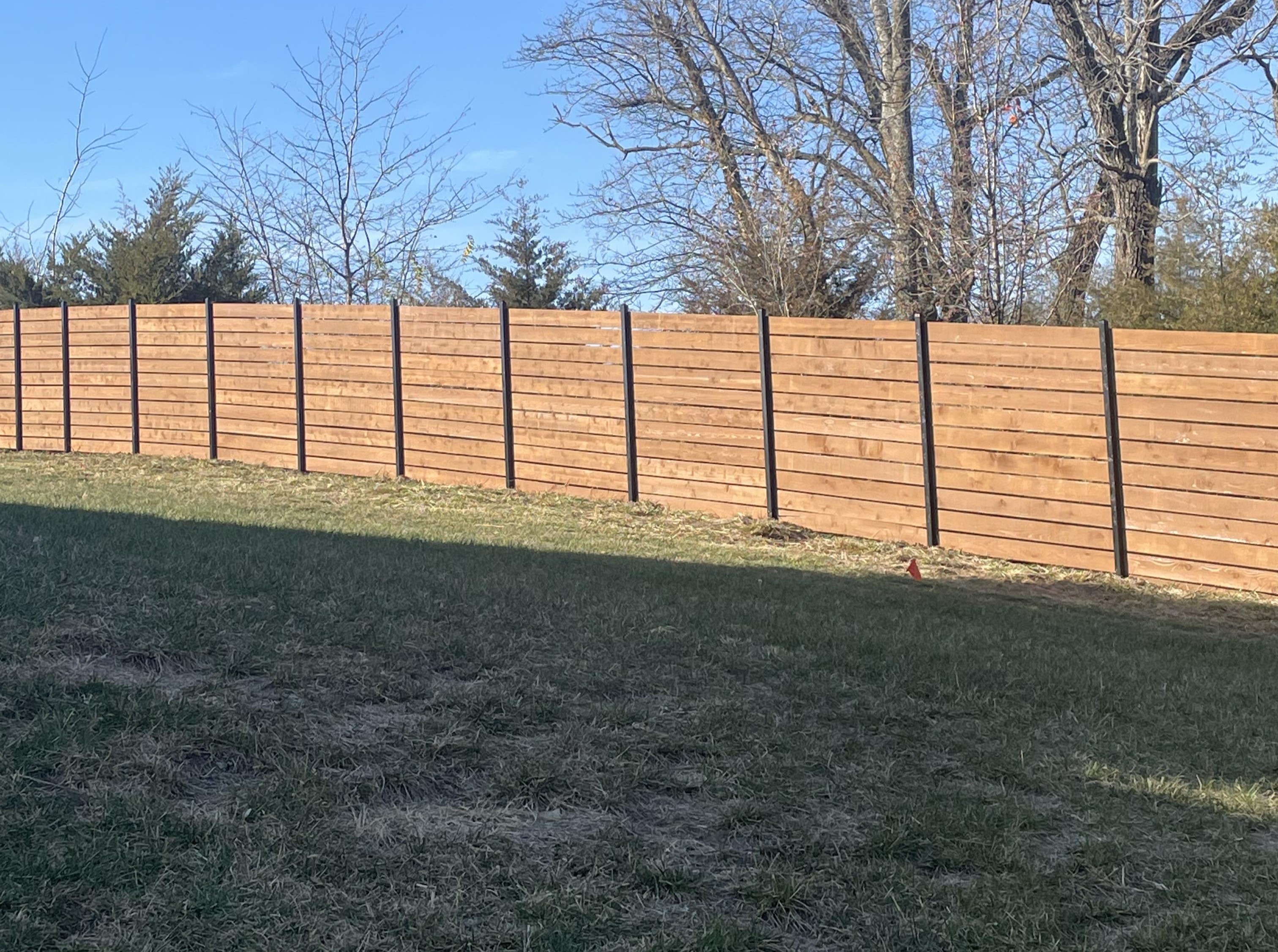 horizontal 8 foot semi privacy wood fence with black posts