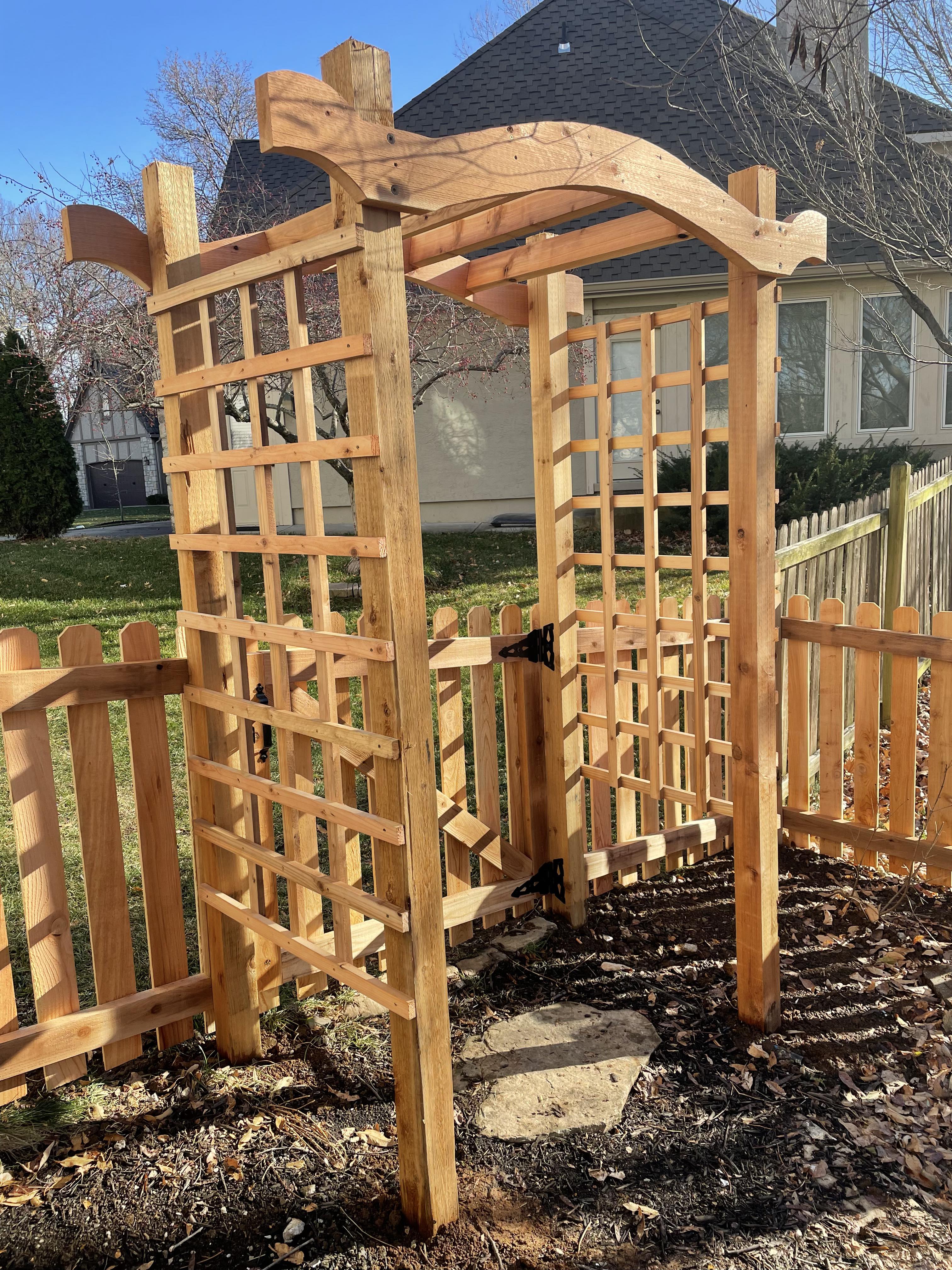 wooden trellis in front of a wooden fence