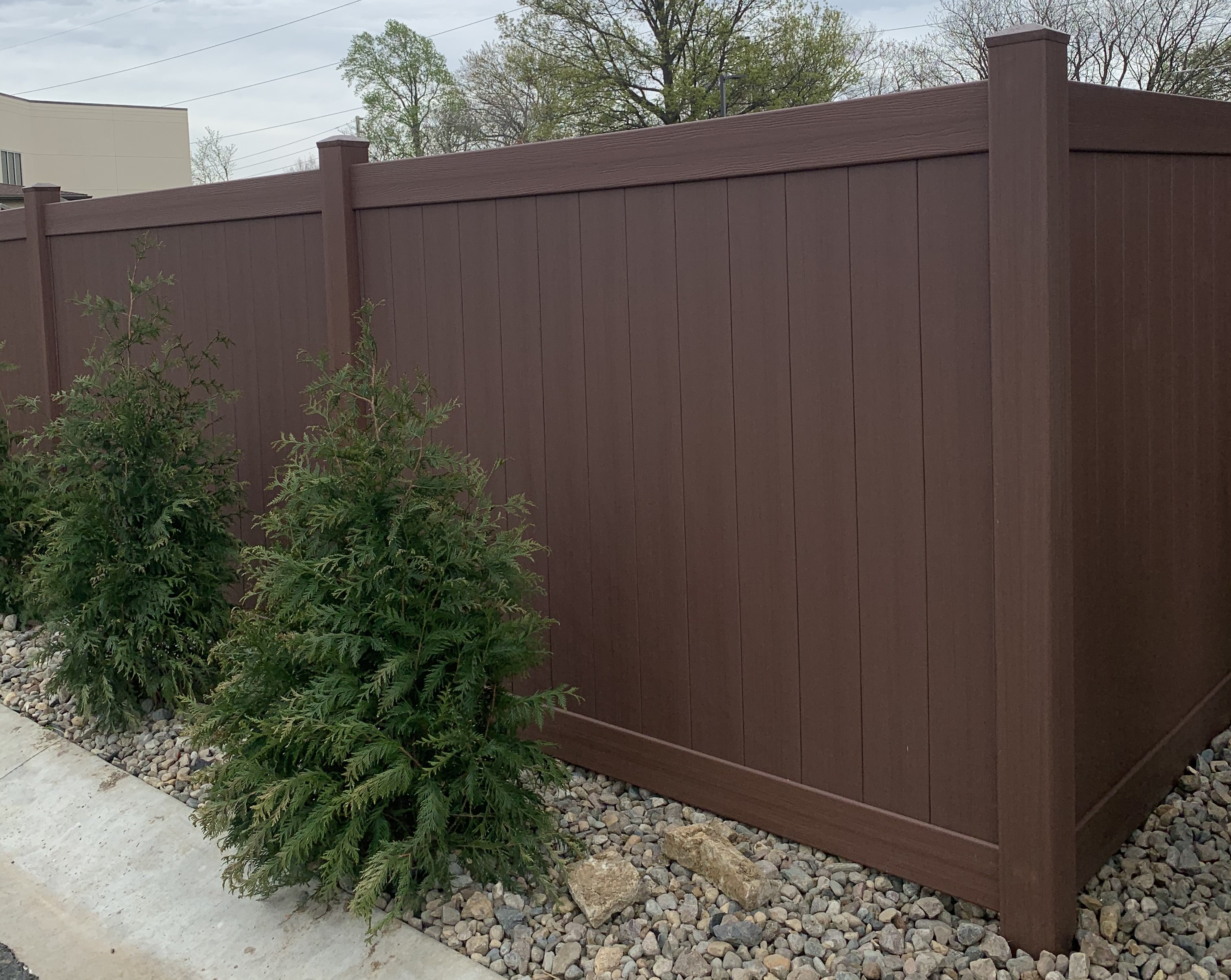 dark brown vinyl fence with a picture frame style